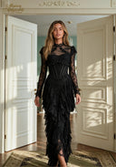 Black lace evening gown with long sleeves, fitted bodice, and layered ruffle skirt