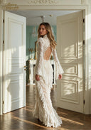 White lace evening gown with long sleeves, fitted bodice, and tiered ruffle skirt