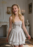 Light blue sleeveless ballet dress with pink ruffle neckline, bow tie waist, layered skirt, lace hem
