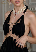 Black halter gown close-up with pearl and crystal necklace-style embellishment