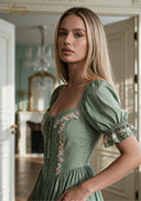 Green puff-sleeve midi dress detail view with floral embroidery on square neckline
