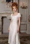 Ivory tulle dress with square neckline, puff sleeves, and front tie