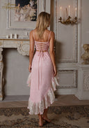 Pink lace backless slip dress with crisscross lacing and layered ruffle hem