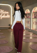 High-waisted straight-leg yoga pants in burgundy, shown from the back