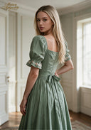 Green puff-sleeve midi dress with square neckline, floral embroidery, and tied back