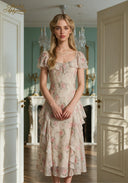 Floral print midi dress featuring puff sleeves, ruffled bodice, and tiered skirt