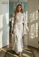 White lace evening gown with high neckline, long sleeves, and tiered ruffle skirt