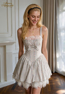 Light blue patterned ballet dress with spaghetti straps, ruched bodice, bow tie, lace ruffle hem