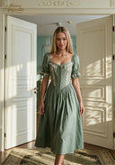 Green puff-sleeve midi dress with square neckline, floral embroidery, and cinched waist