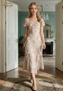 Floral print dress with short puff sleeves, ruffled neckline, and layered midi hem