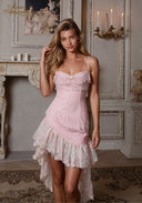 Pink lace slip dress with off-shoulder ruffle neckline and layered tiered skirt