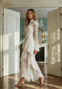 White lace evening gown with long sleeves and fitted waist with ruffle trim