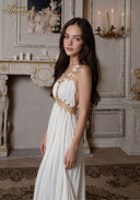 Star of Crystal Gown in white, angled view with gold beadwork halter and flowing tiered skirt
