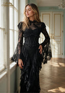 Black lace evening gown with long bell sleeves, fitted waist, and layered ruffle skirt