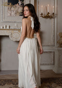 Star of Crystal Gown in white, side view with open back, gold halter detailing, maxi skirt