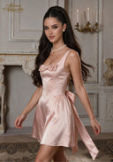 Rose satin mini dress with gathered waist bow and flowing ribbon ties