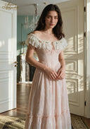 Blush embroidered off-shoulder dress with fitted waist, ribbon tie, and layered skirt