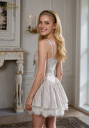 Light blue ballet dress in profile view, spaghetti straps, bow waist, layered skirt, lace hem