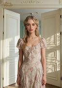 Floral print midi dress with square neckline, short puff sleeves, and layered ruffle skirt