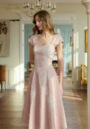 Pink lace midi dress with square neckline and cap sleeves, fitted waist and flared hem