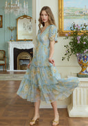Light blue floral midi dress with puff sleeves and flowing tiered skirt