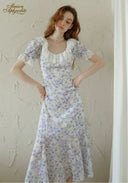 Lavender floral midi dress close-up: square neckline, puff sleeves, fitted waist, skirt flare.