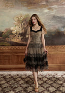 Lace mesh midi dress with dark lace square neckline, short puff sleeves, and layered tiers