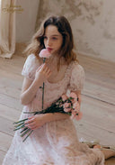Light pink lace tea dress with puff sleeves, square neckline, and ruffled skirt