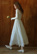 White lace ballet journal dress with long sleeves and full skirt, profile view
