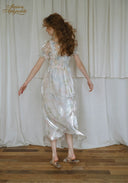 Floral satin midi dress back view with puff sleeves, gathered waist, silver sheen