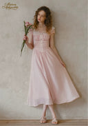 Pale pink dotted midi dress with ruffled neckline, lace corset bodice, and full skirt
