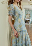 Light blue floral V-neck midi dress with puff sleeves and ruched bodice