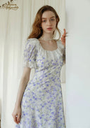Lavender floral midi dress close-up: square neckline, puff sleeves, fitted bodice.