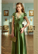 Green satin long dress with lace-trim V neckline, short puff sleeves, fitted bodice and long skirt