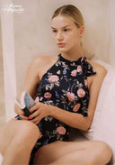 Floral halter swim one-piece with bow at neckline, dark base with pink and light flowers