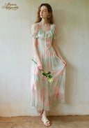 Pastel floral tiered dress with puff sleeves, lace trim, and open neckline