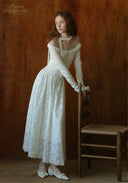 White lace ballet journal dress with off-shoulder neckline and long sleeves, side pose