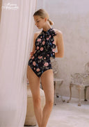 Floral black one-piece swimsuit with high neck and tie bow at the back