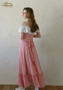 Back view of gingham plaid maxi dress with off-shoulder white lace and tied waist