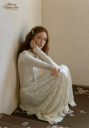 White lace ballet journal dress with long sleeves and full skirt, seated side view