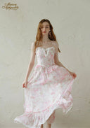Light pink floral dress with lace bodice, spaghetti straps, flowing tiered ruffle skirt