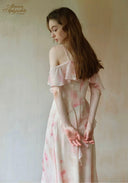 Light pink floral maxi dress viewed from the side, thin straps and ruffle sleeves