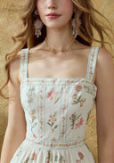 Close-up of floral cotton suspender dress bodice with square neckline and straps