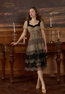 Black mesh lace dress with V-neck bodice, short puff sleeves, and tiered ruffle hem