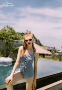 Light blue tie-front one-piece swimsuit with lace-up detail at center front