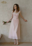 Pale pink dotted midi dress with ruffled cap sleeves and layered lace details