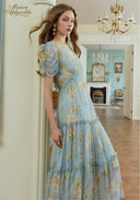 Light blue floral midi dress with puff sleeves and gathered waist detail