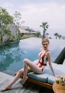 Orange and white striped halter one-piece swimsuit with tie straps