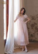 Light pink floral tea dress with puff sleeves, fitted waist with ribbon tie, midi tiered skirt.