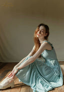 Light blue tiered midi dress with lace-trim neckline, spaghetti straps and soft gathered tiers